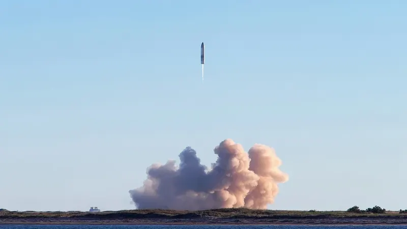 SpaceX Starship lifting off above a cloud of exhaust at Starbase, Texas